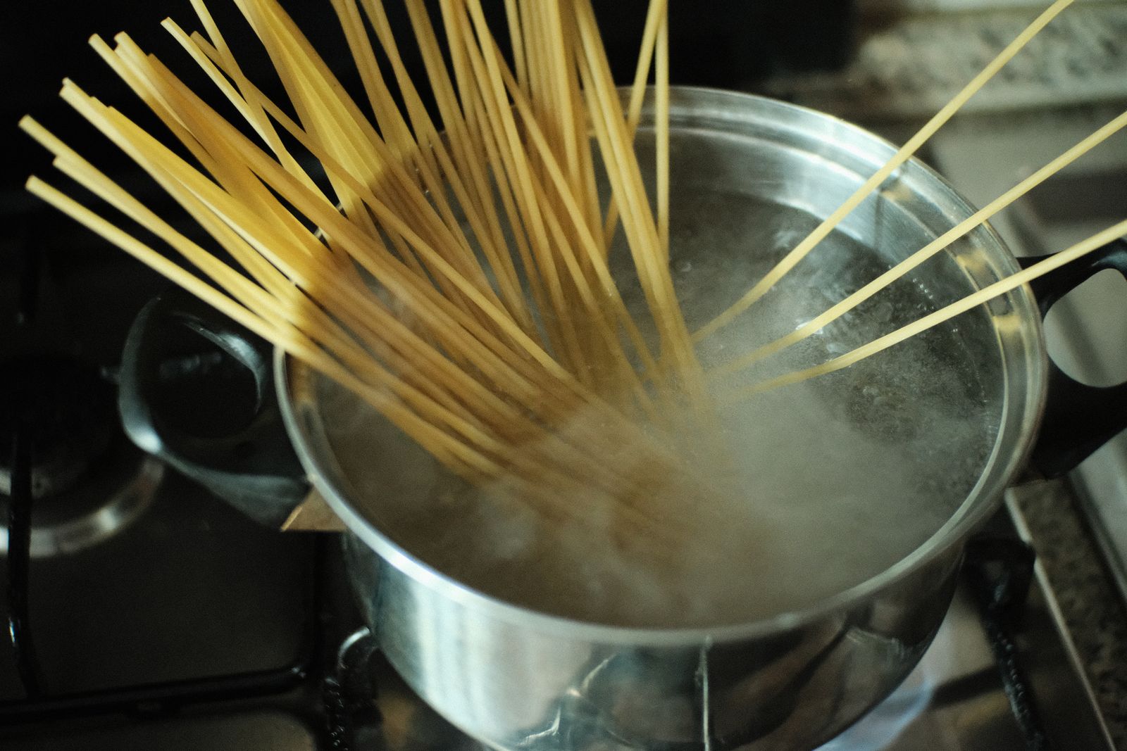 Legume pasta cooking in a pot of boiling water on a stovetop