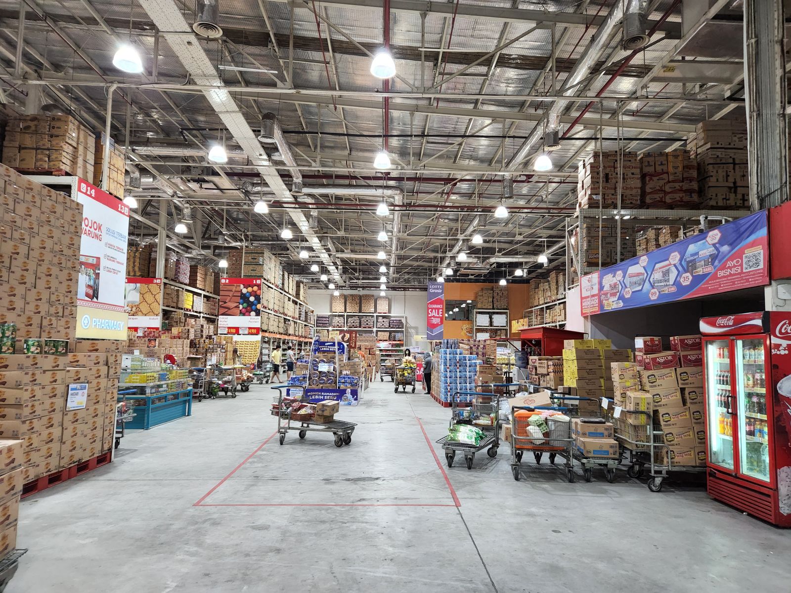 Industrial warehouse-club store interior with tall shelving aisles