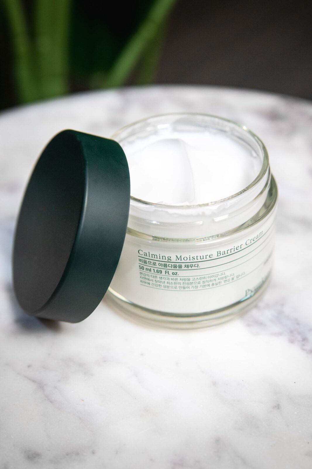 A skincare beauty product jar on a table