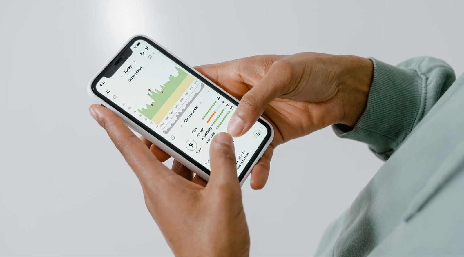 Close-up of a person reviewing a health chart on a smartphone app