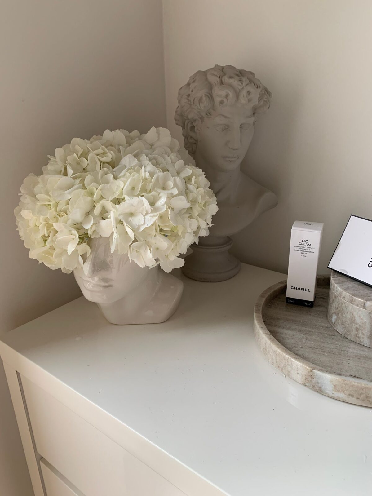Minimalist aluminum-free deodorant stick on a marble bathroom counter