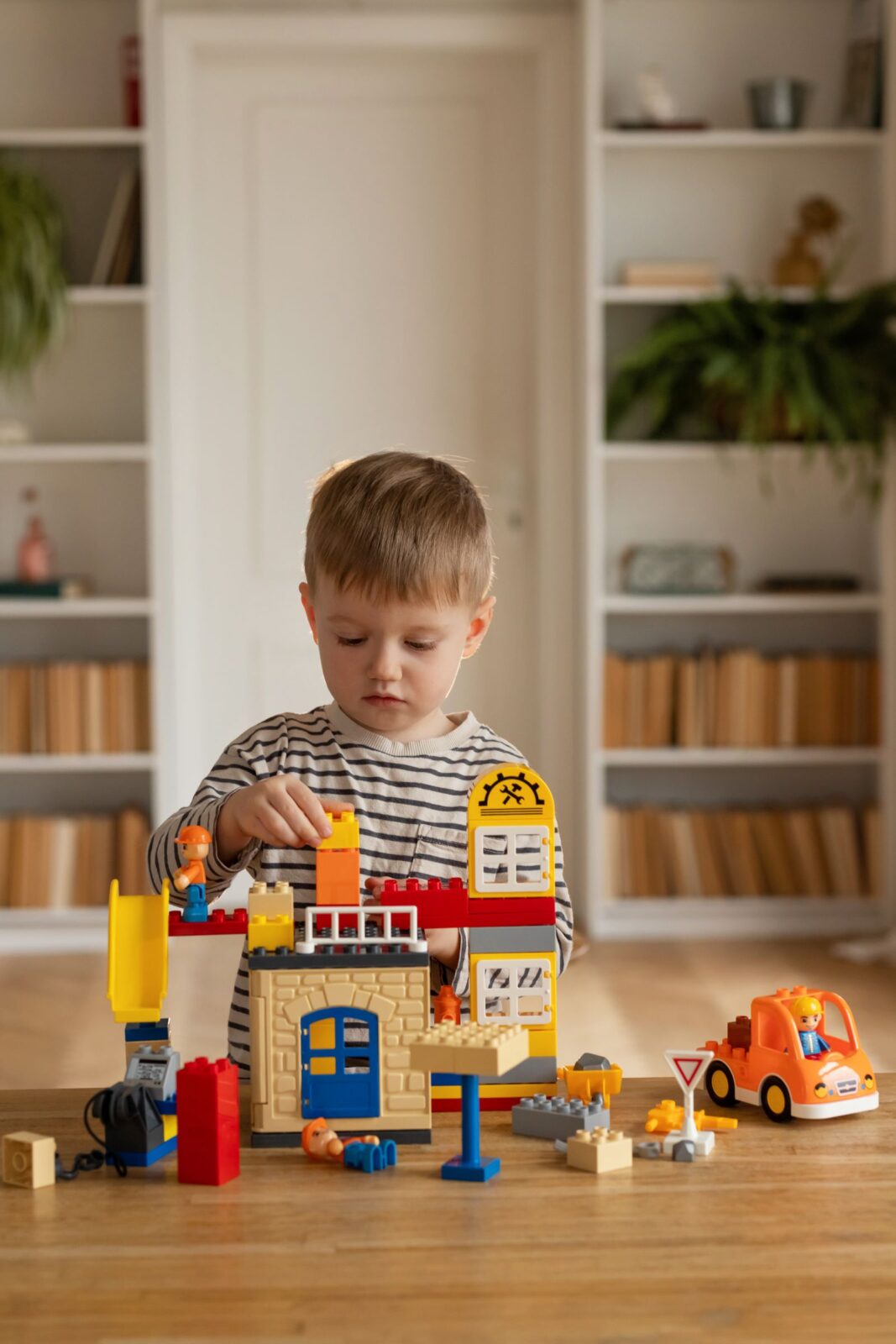 A young child building a structure from blocks