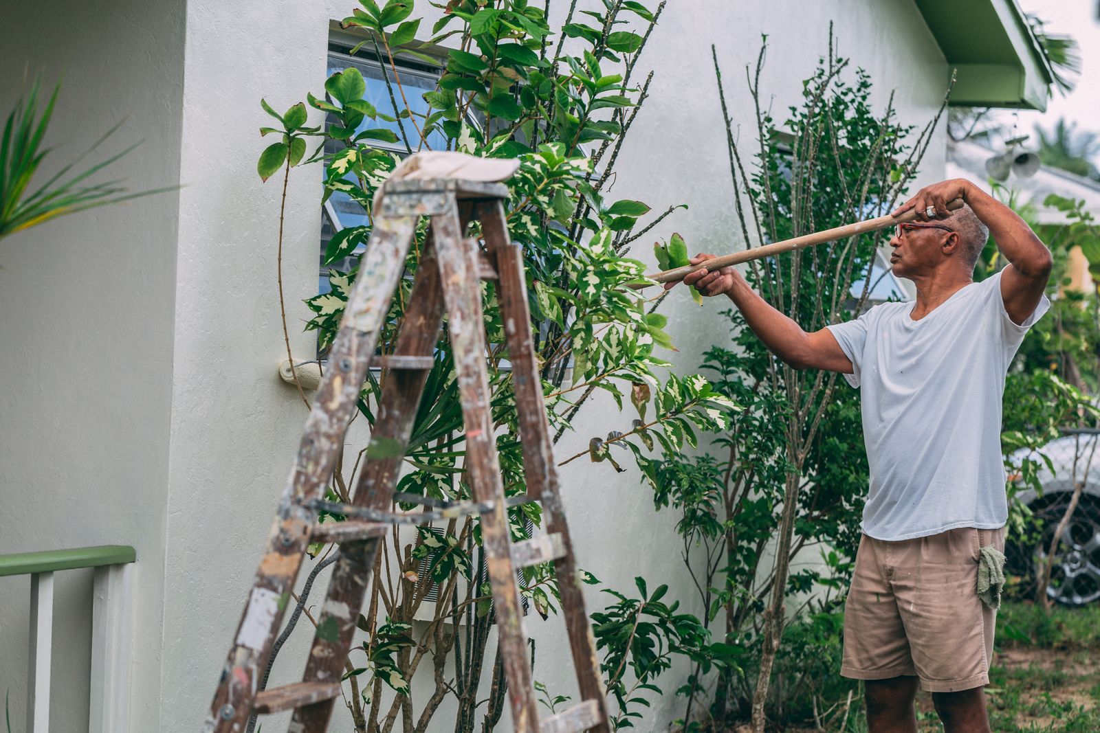 A person painting the exterior of a house