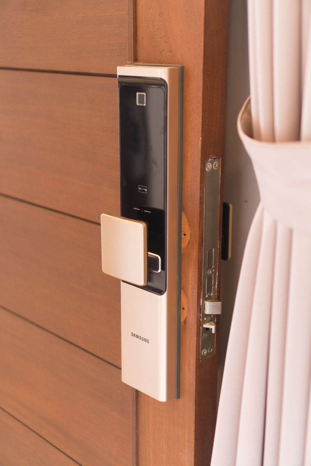 Modern smart deadbolt with touchscreen keypad on a front door