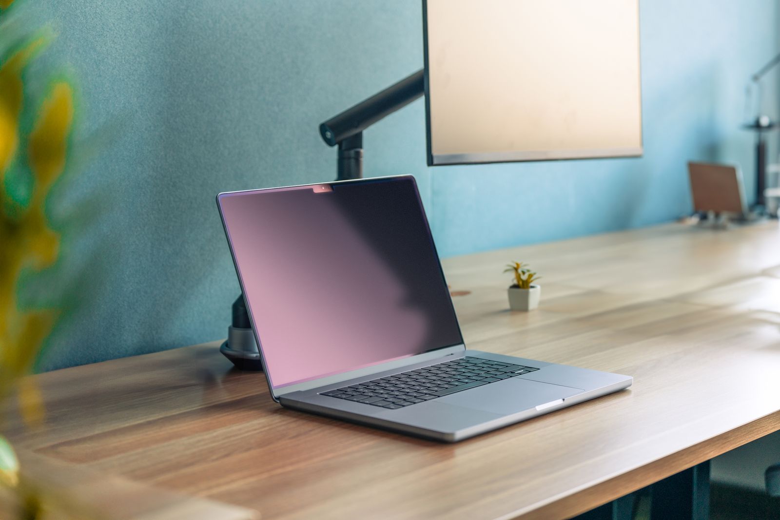 A laptop open on a clean wooden desk