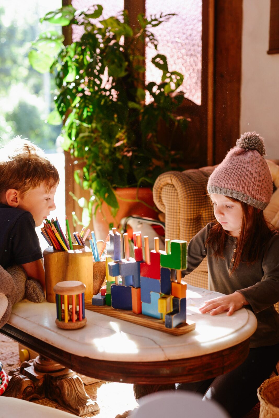 Children building with colorful construction blocks on a table