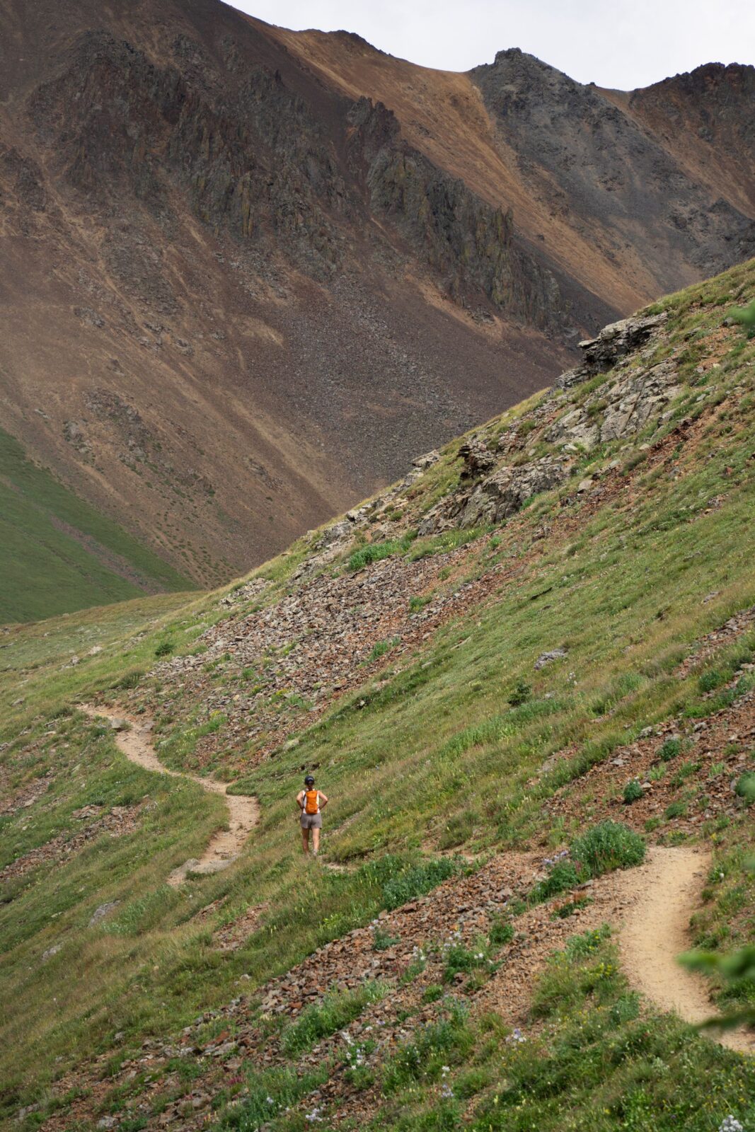 A person hiking up a mountain trail