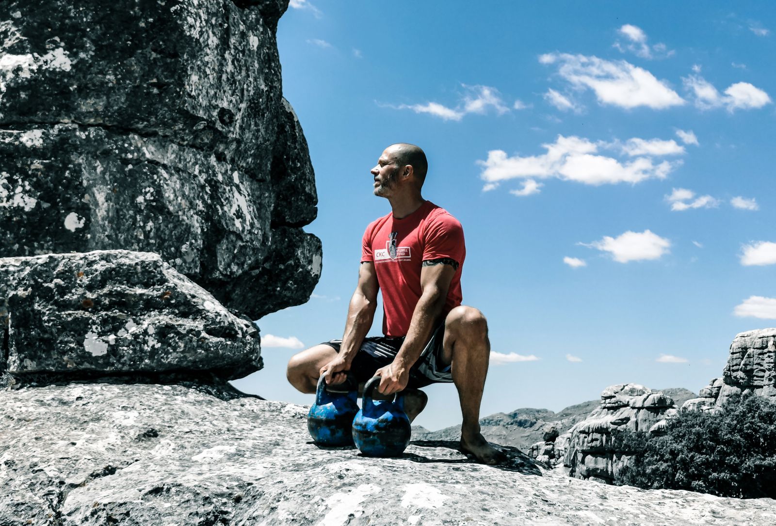 Person holding kettlebells during a workout