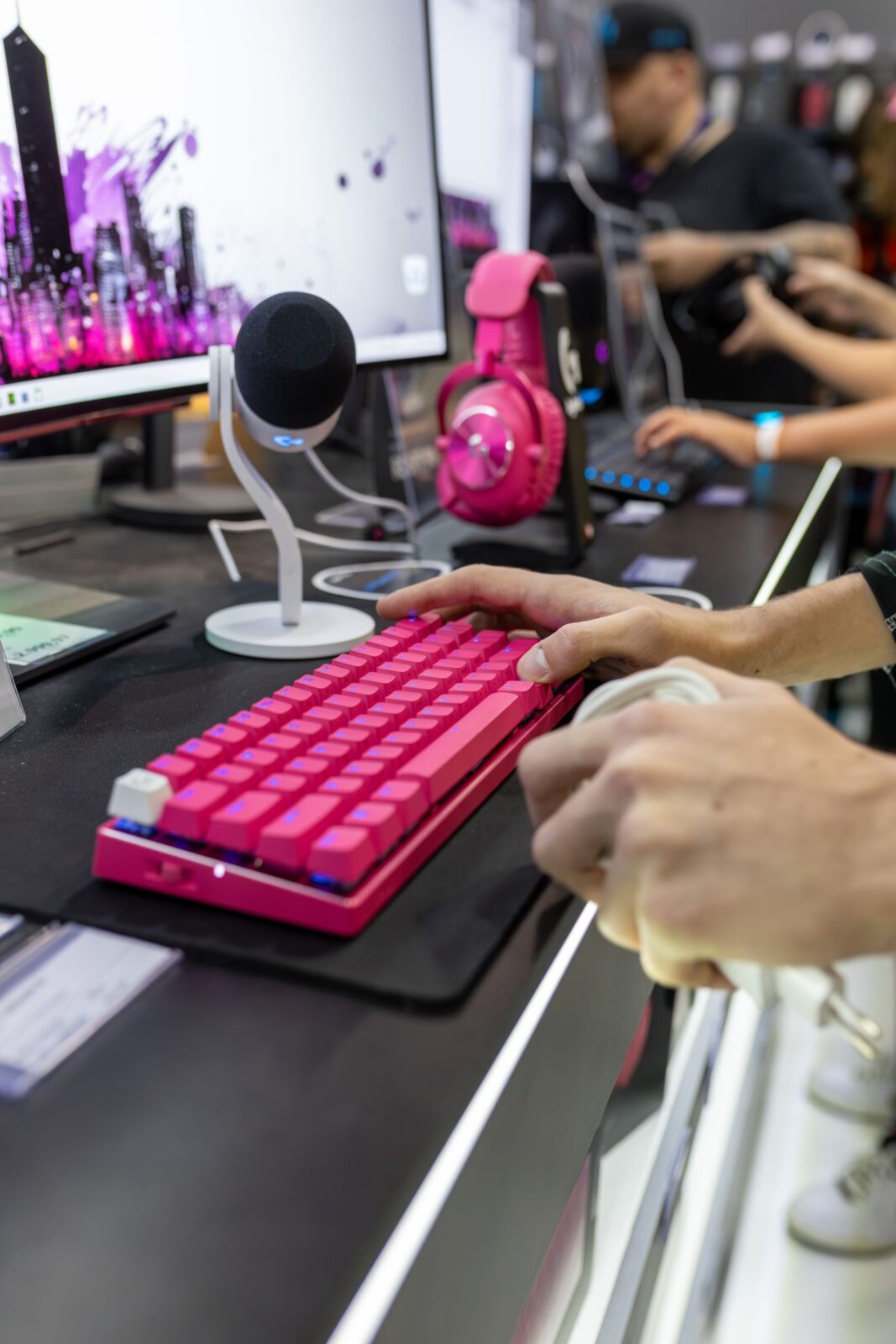 Gaming setup with a wireless headset and backlit keyboard on a desk