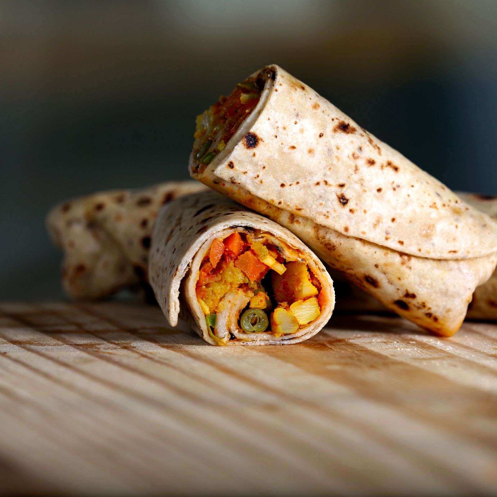 A large wrap rolled burrito-style and sliced in half