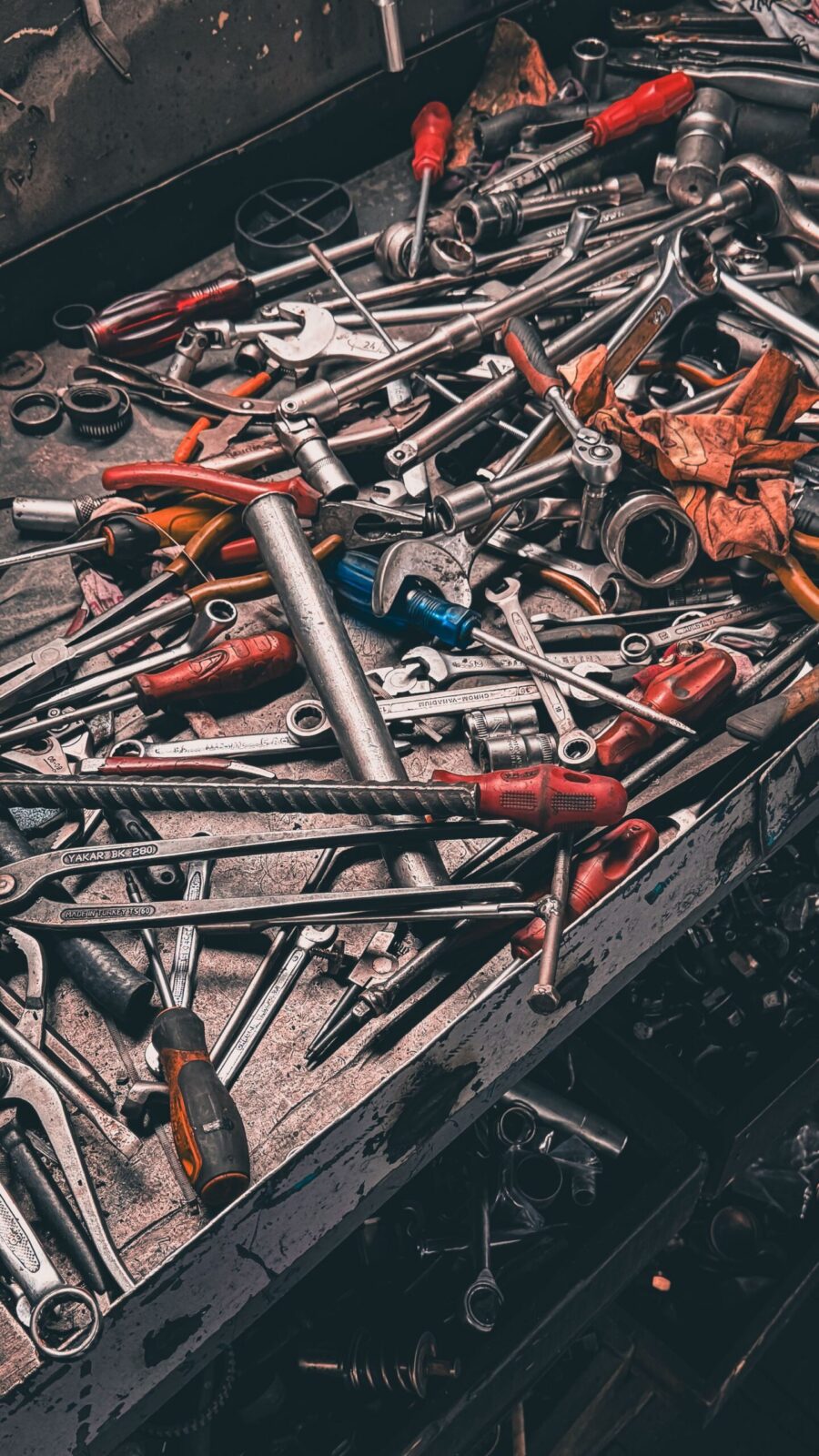 Assorted hand tools organized on a garage workbench