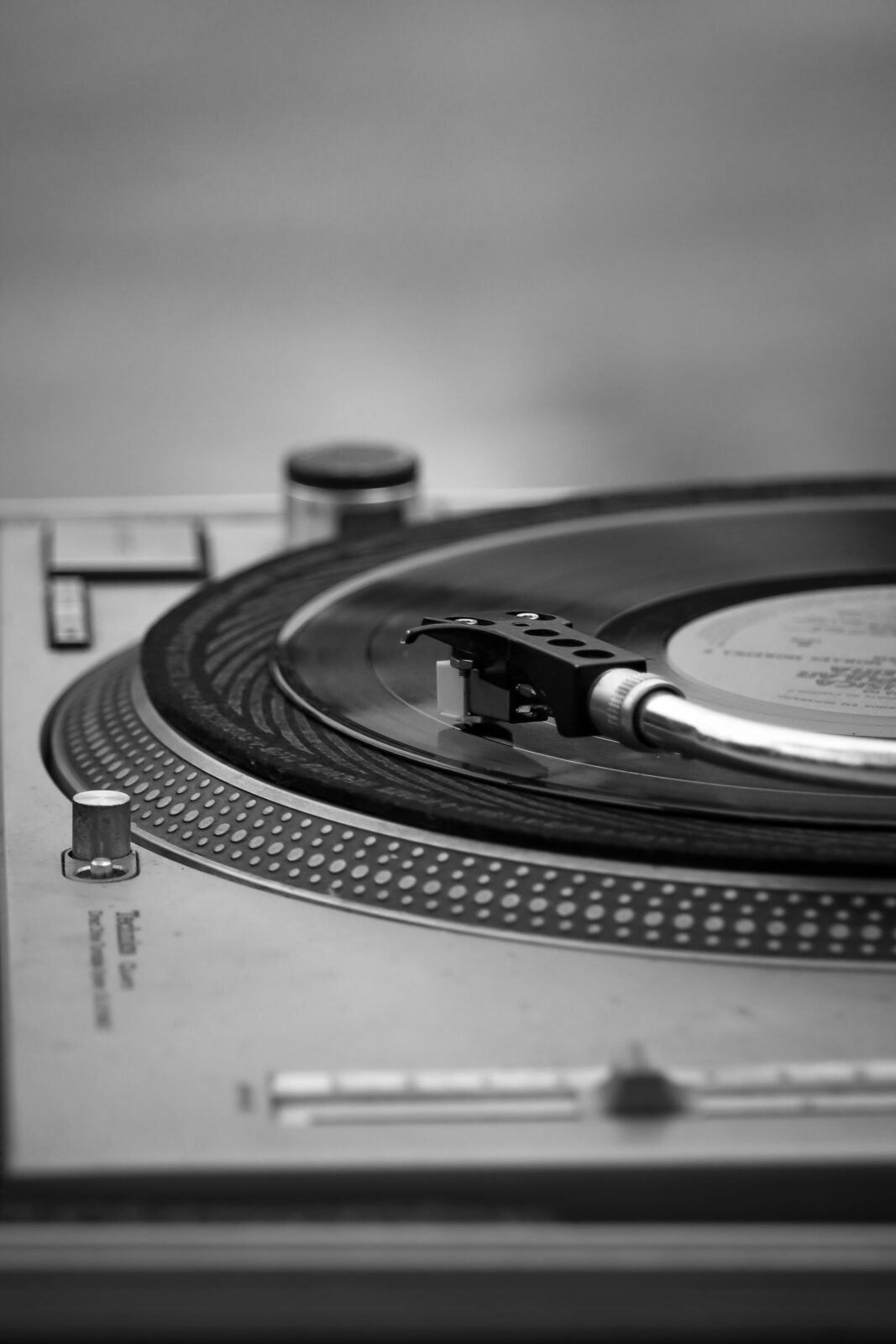 Close-up of a turntable stylus tracking a spinning vinyl record