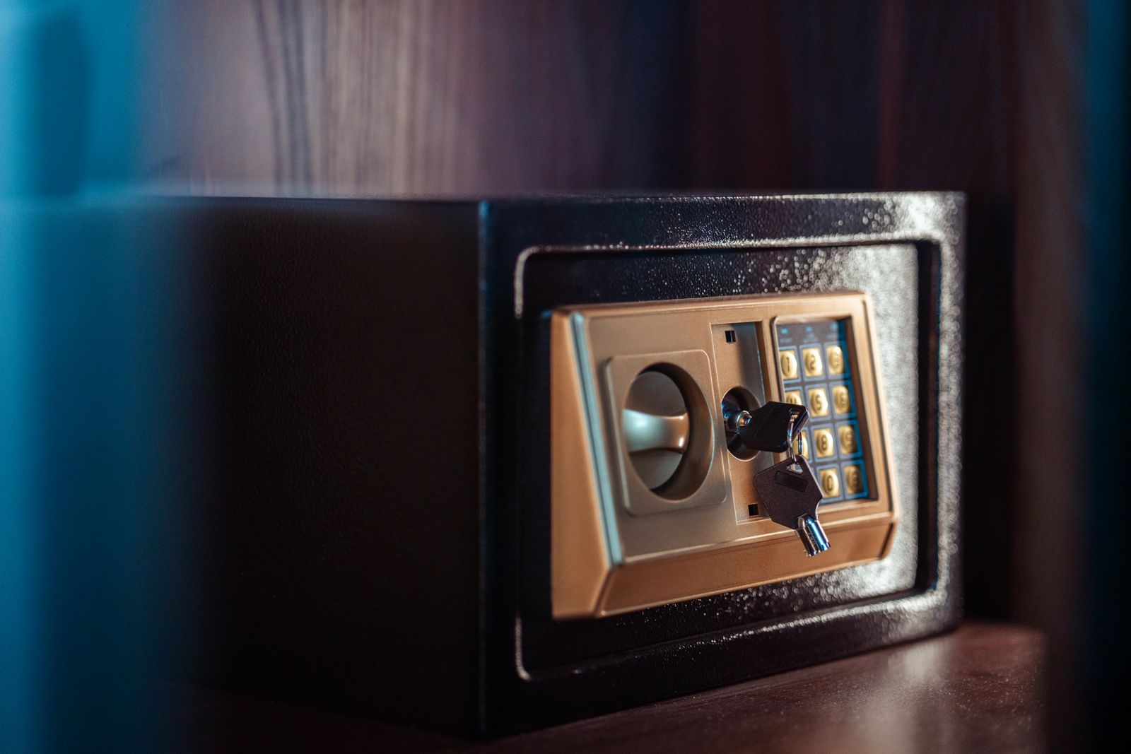 Close-up of a black metal fireproof home safe with a digital keypad and key lock