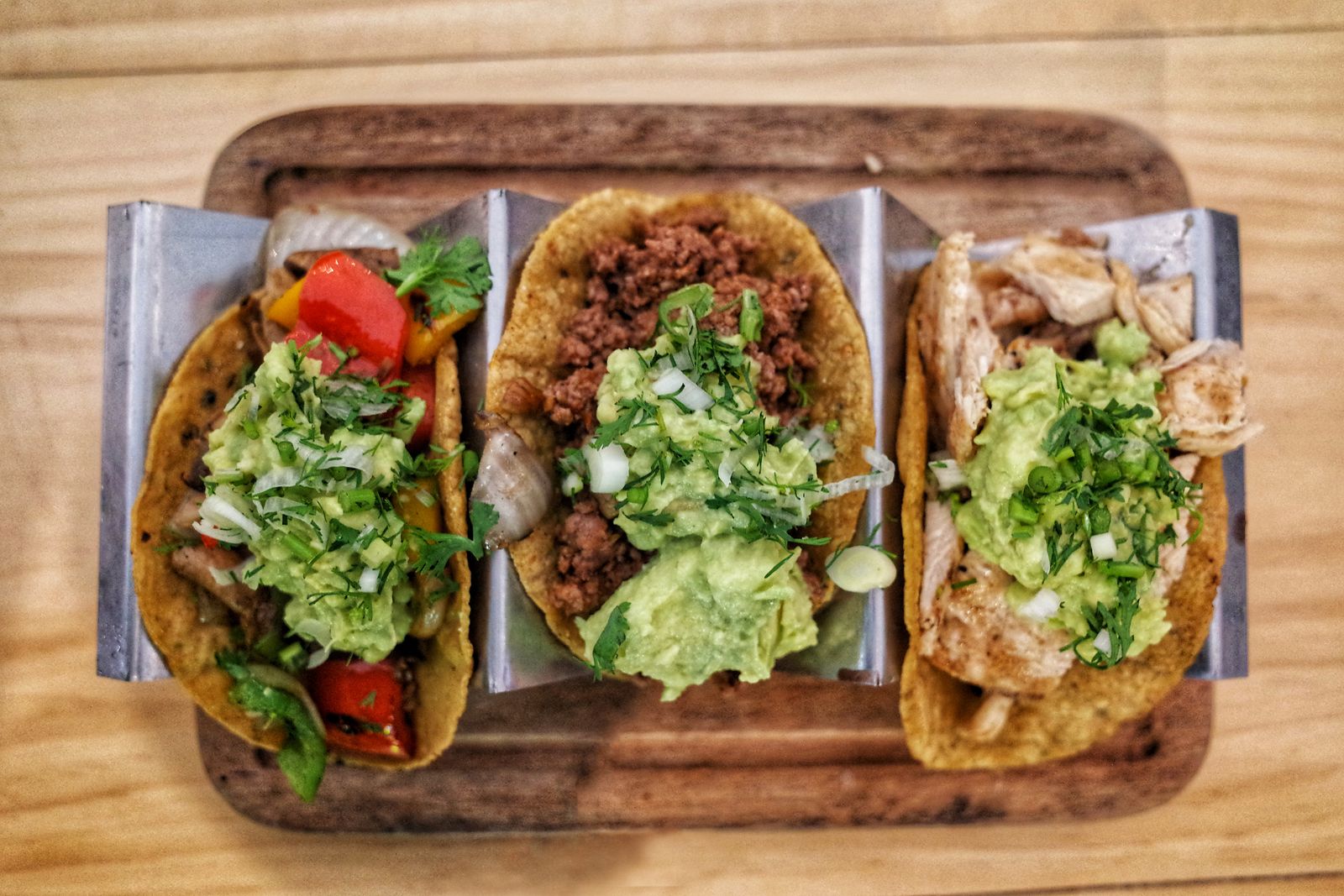 Soft tortillas folded into tacos with fresh toppings