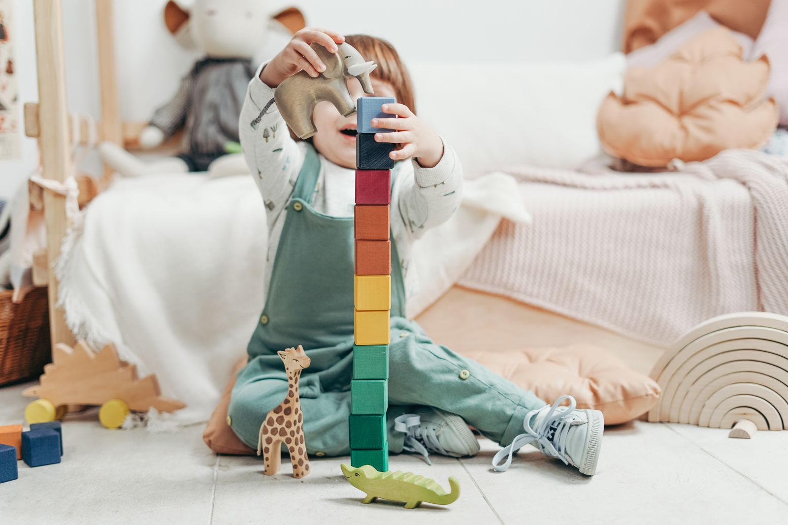 A preschooler building with colorful magnetic tiles