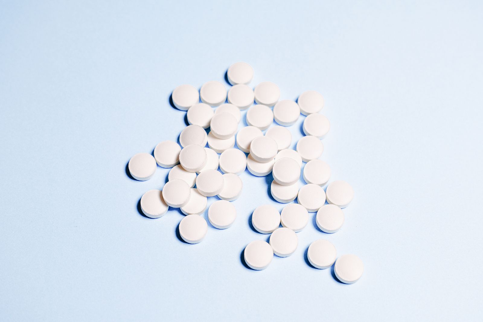 White round medication tablets on a light surface