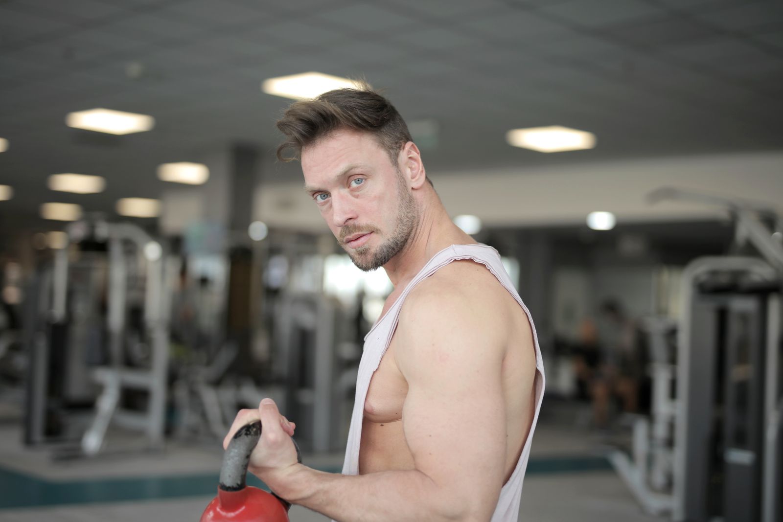 Athlete holding a kettlebell while training in a gym