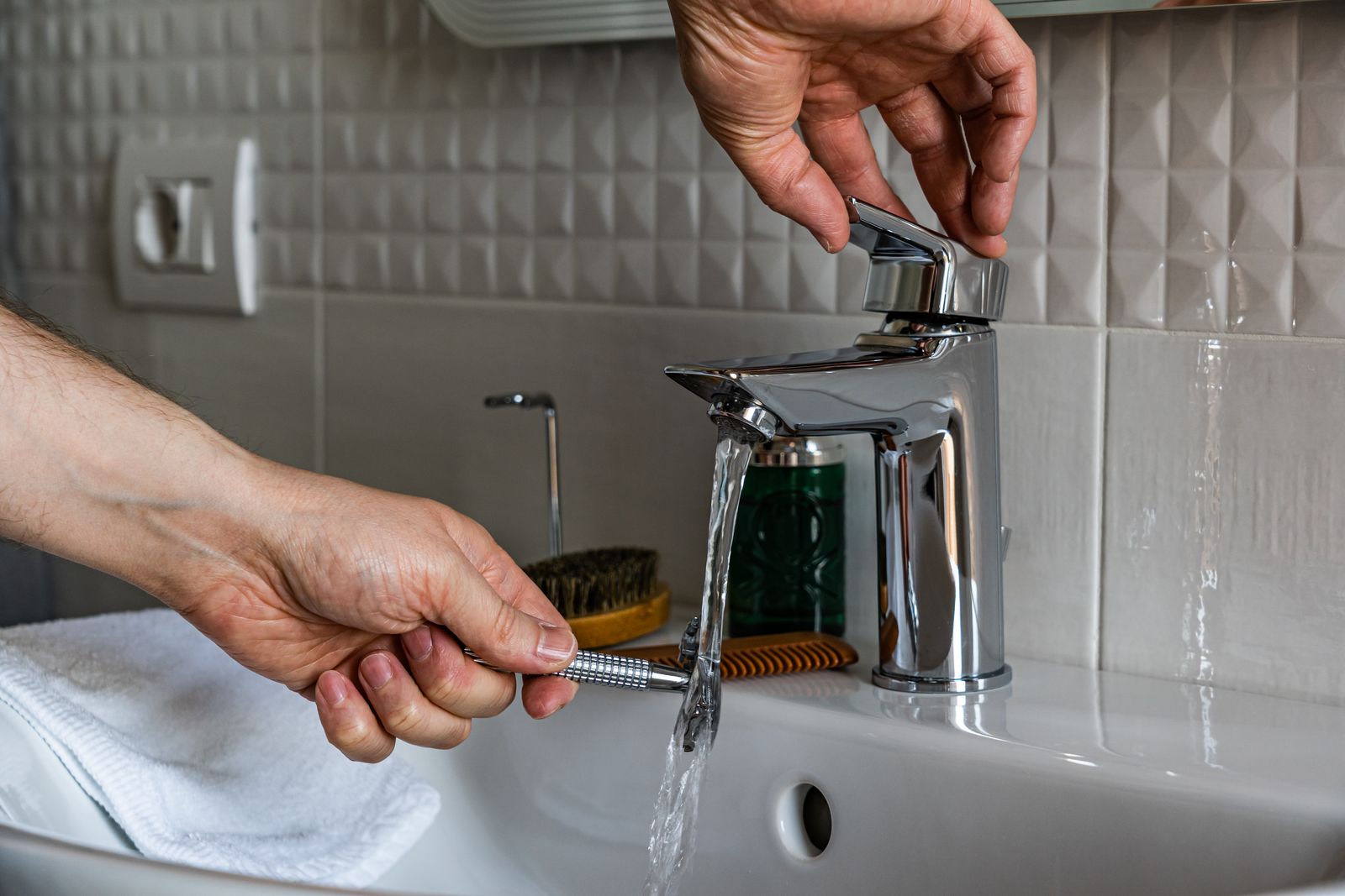 A modern electric foil shaver resting on a bright bathroom counter