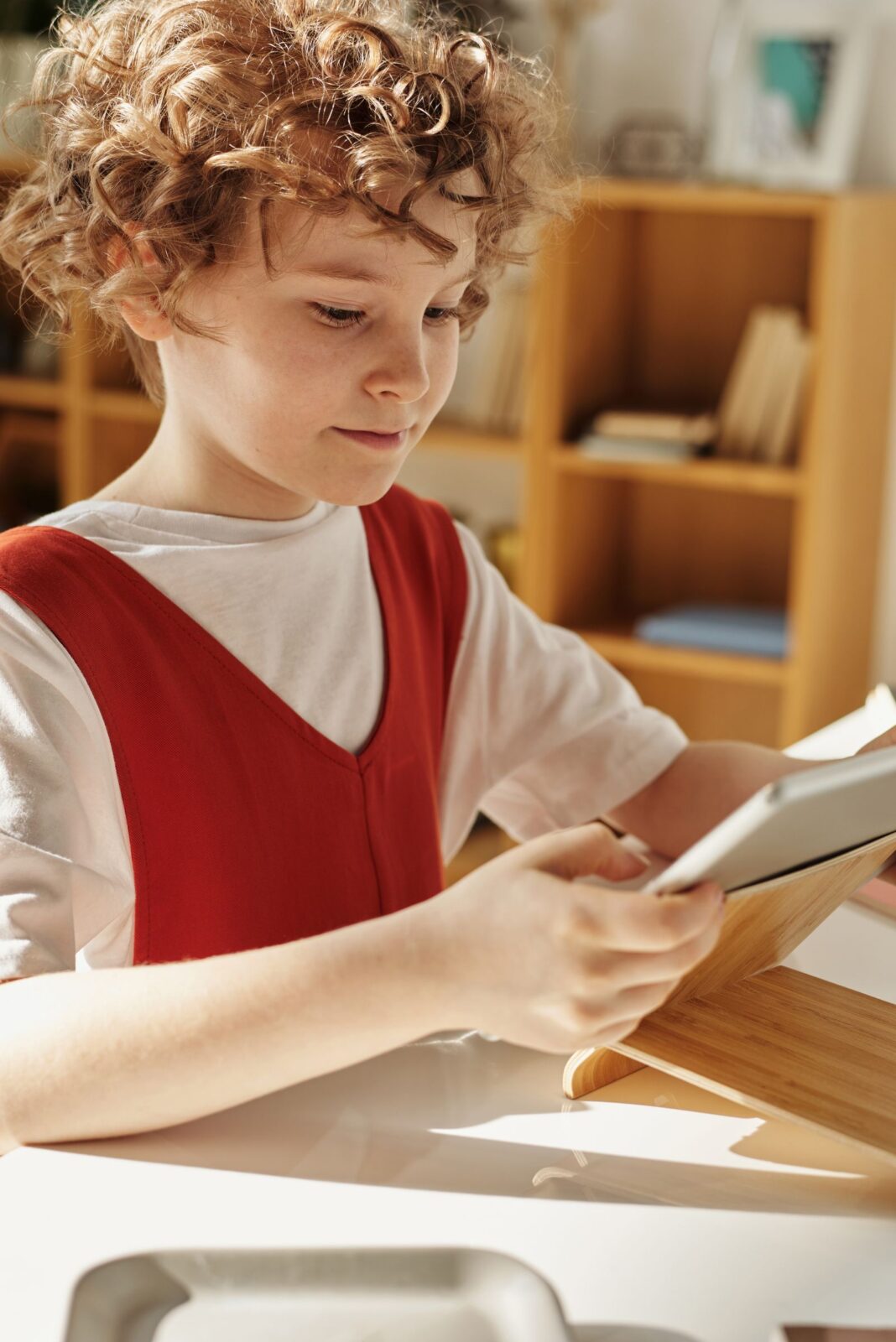 A child using a tablet computer for a learning app