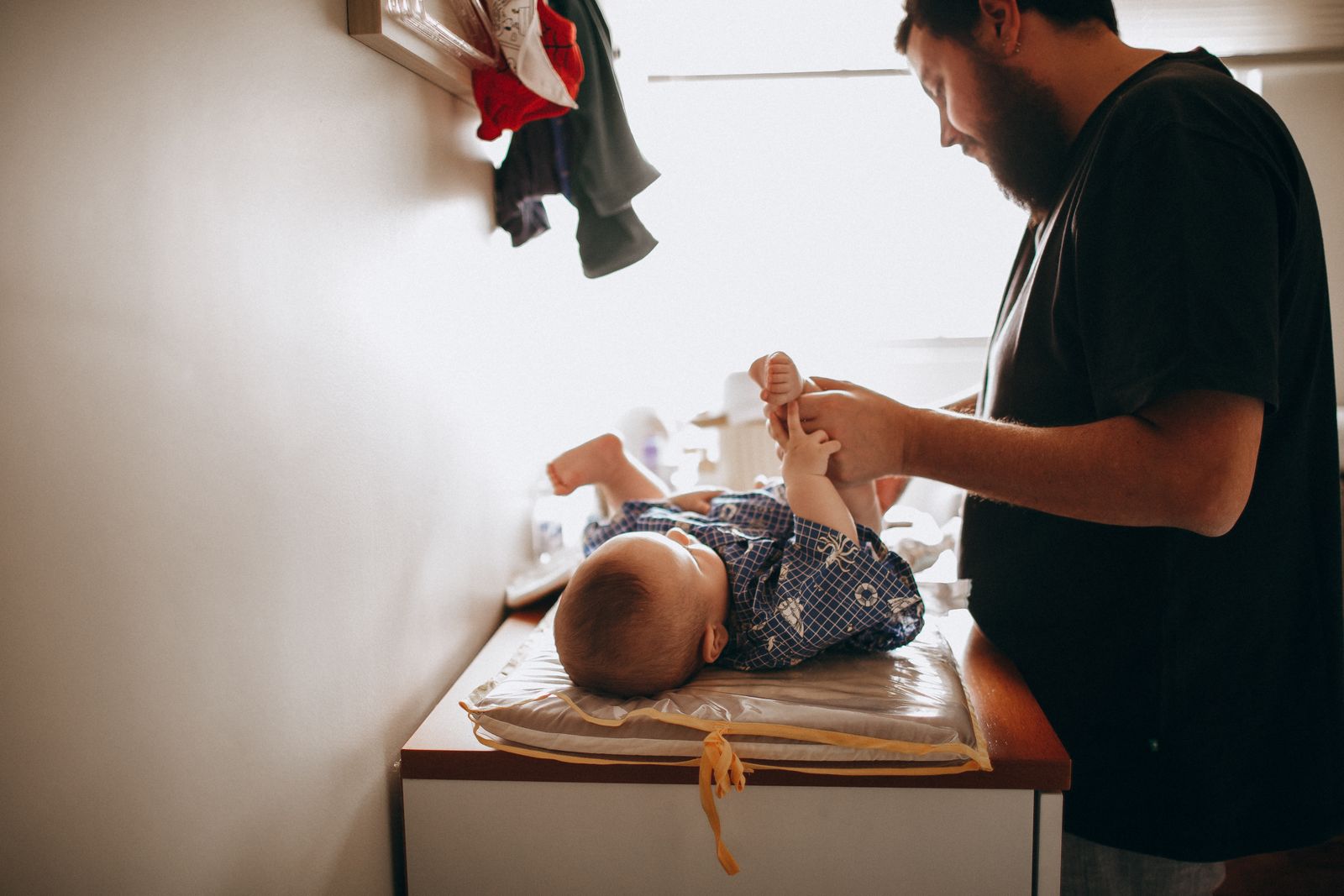 A parent changing a newborn baby's diaper
