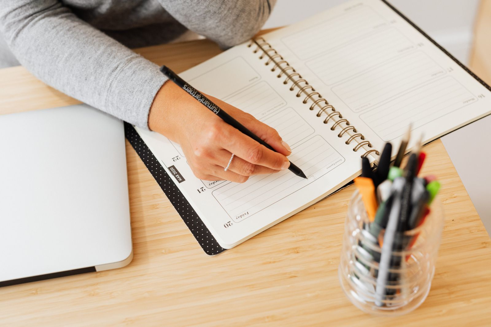 A person writing in a planner