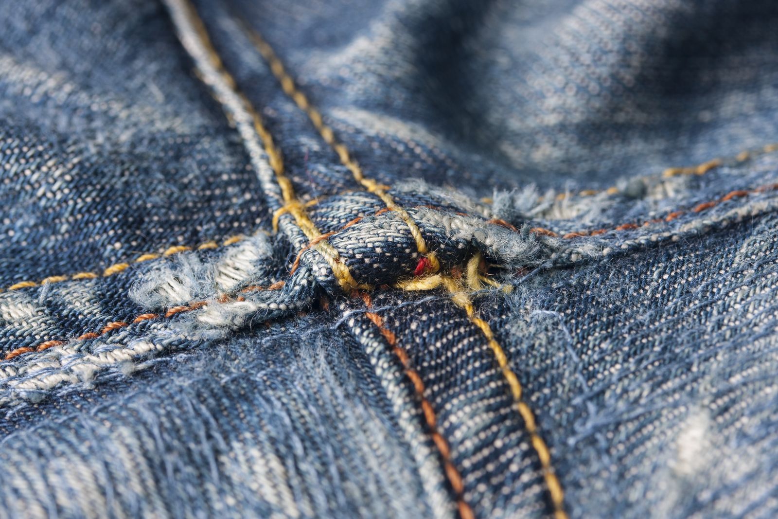 Folded blue denim, the kind of thick fabric a heavy-duty machine handles