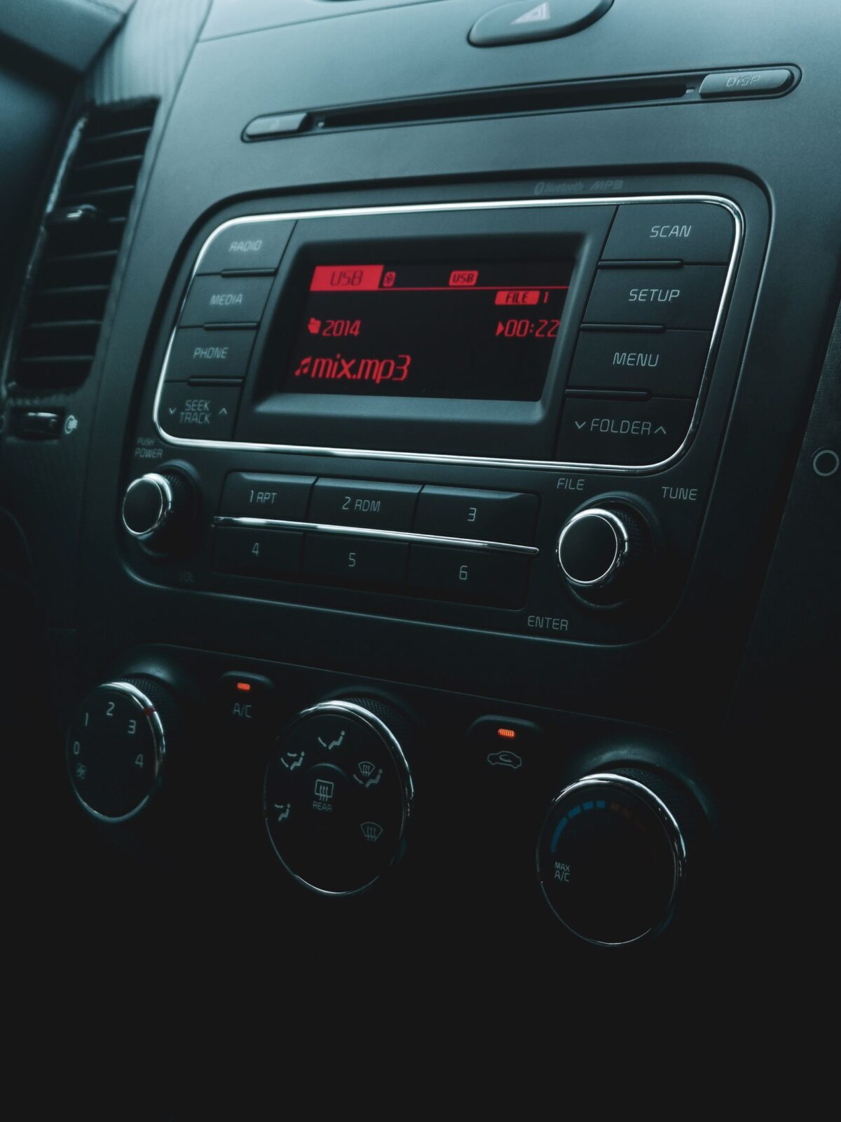 Small wireless CarPlay adapter dongle near a car dashboard USB port