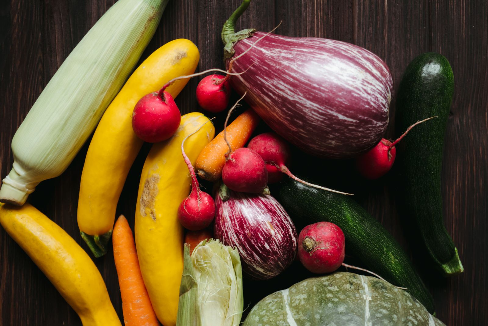 A colorful spread of fresh whole foods on a wooden table