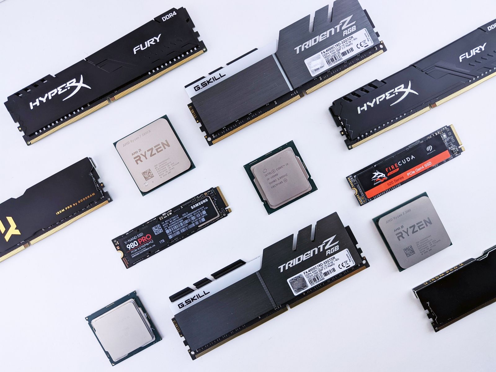 Computer RAM modules and an SSD on a clean surface