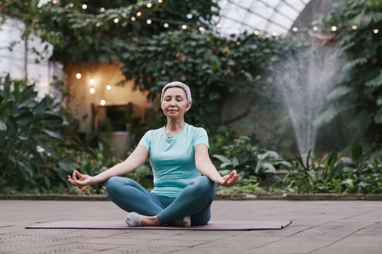 Woman sitting with eyes closed in a calm, relaxed pose