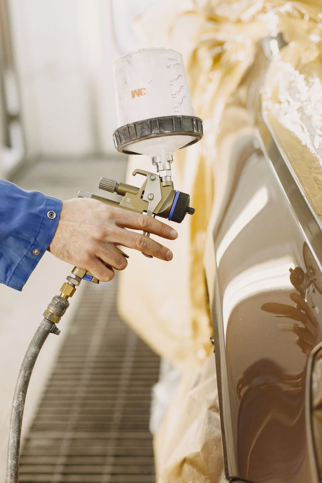 Person using a handheld paint spray gun