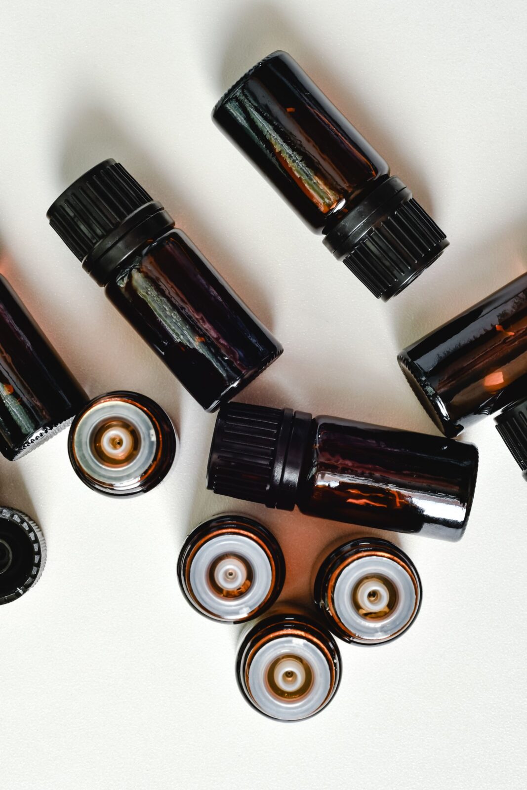 Several essential oil bottles arranged on a clean white surface
