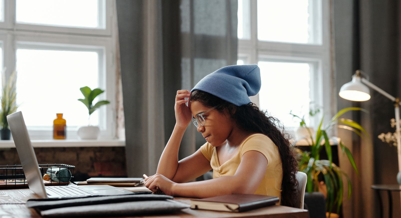 Student sitting at a desk studying on a budget Windows laptop