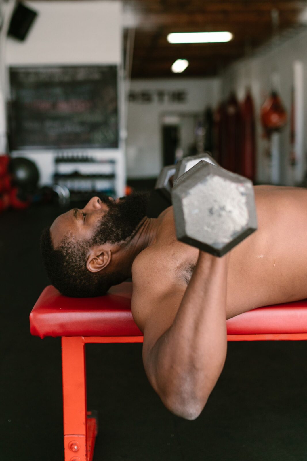 Person lifting weights during a strength-training session in a home gym