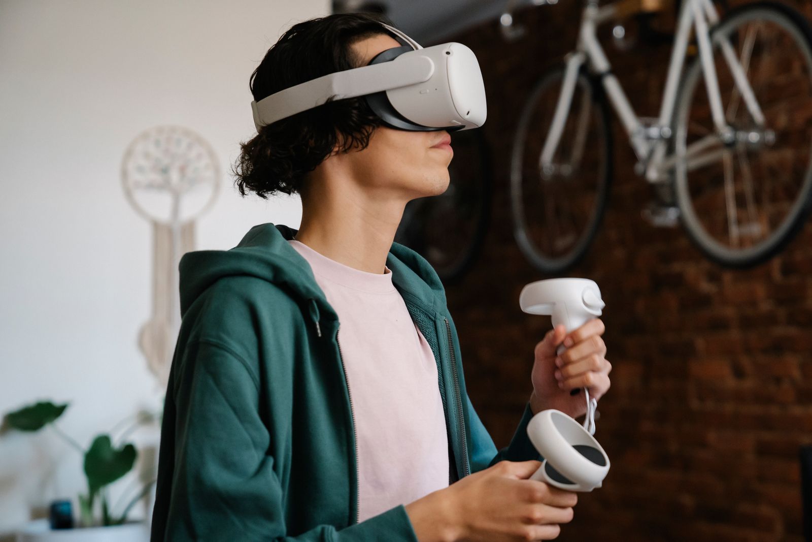 A focused gamer wearing a wireless headset while playing a video game