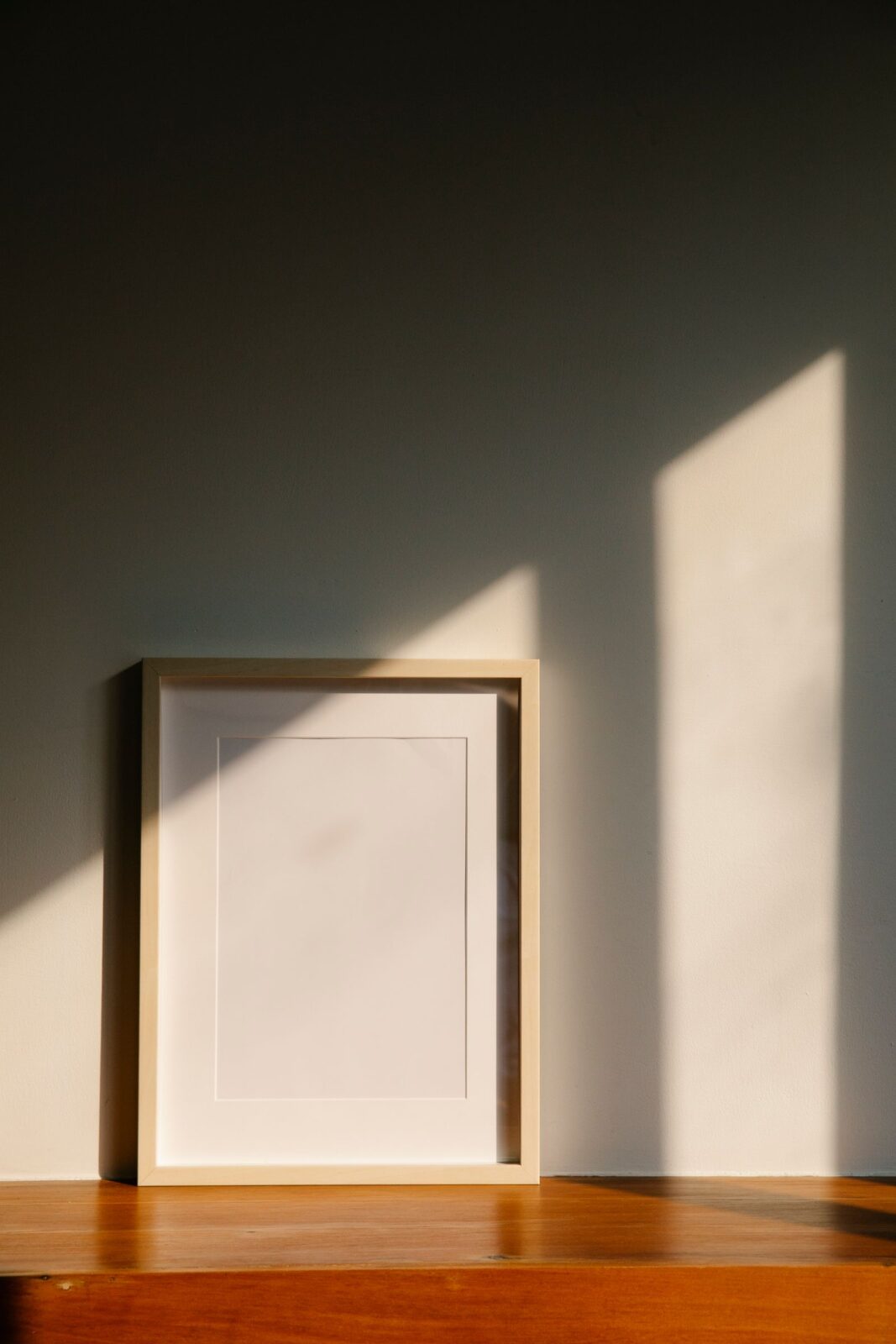 A picture frame displayed on a wooden shelf in a home