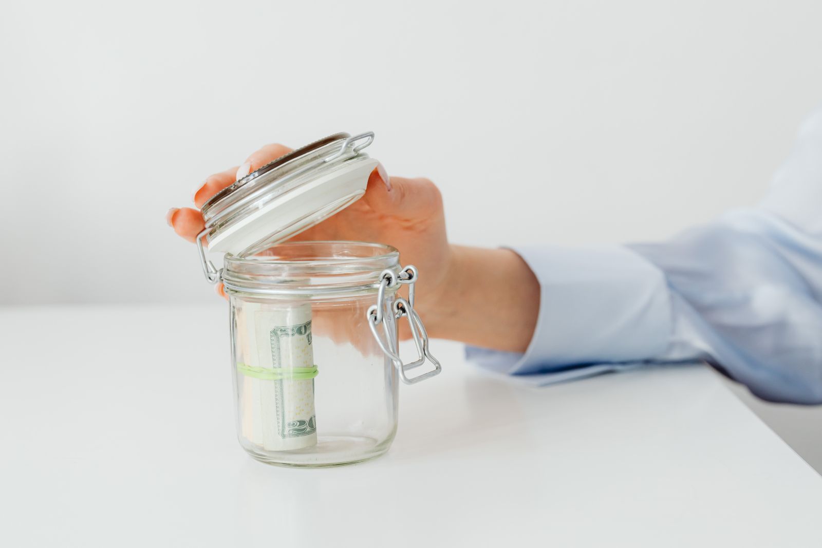 A person saving money in a glass jar representing lower-cost options