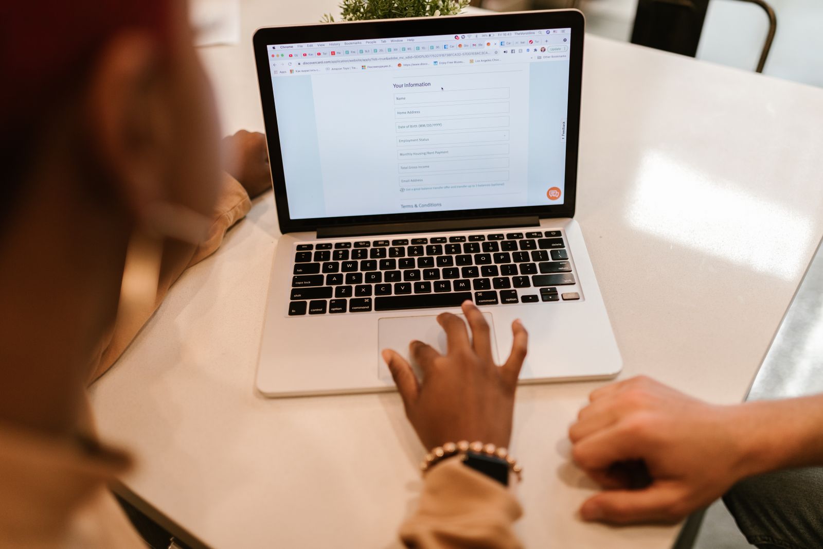 Close-up of a person filling out an online health form on a laptop
