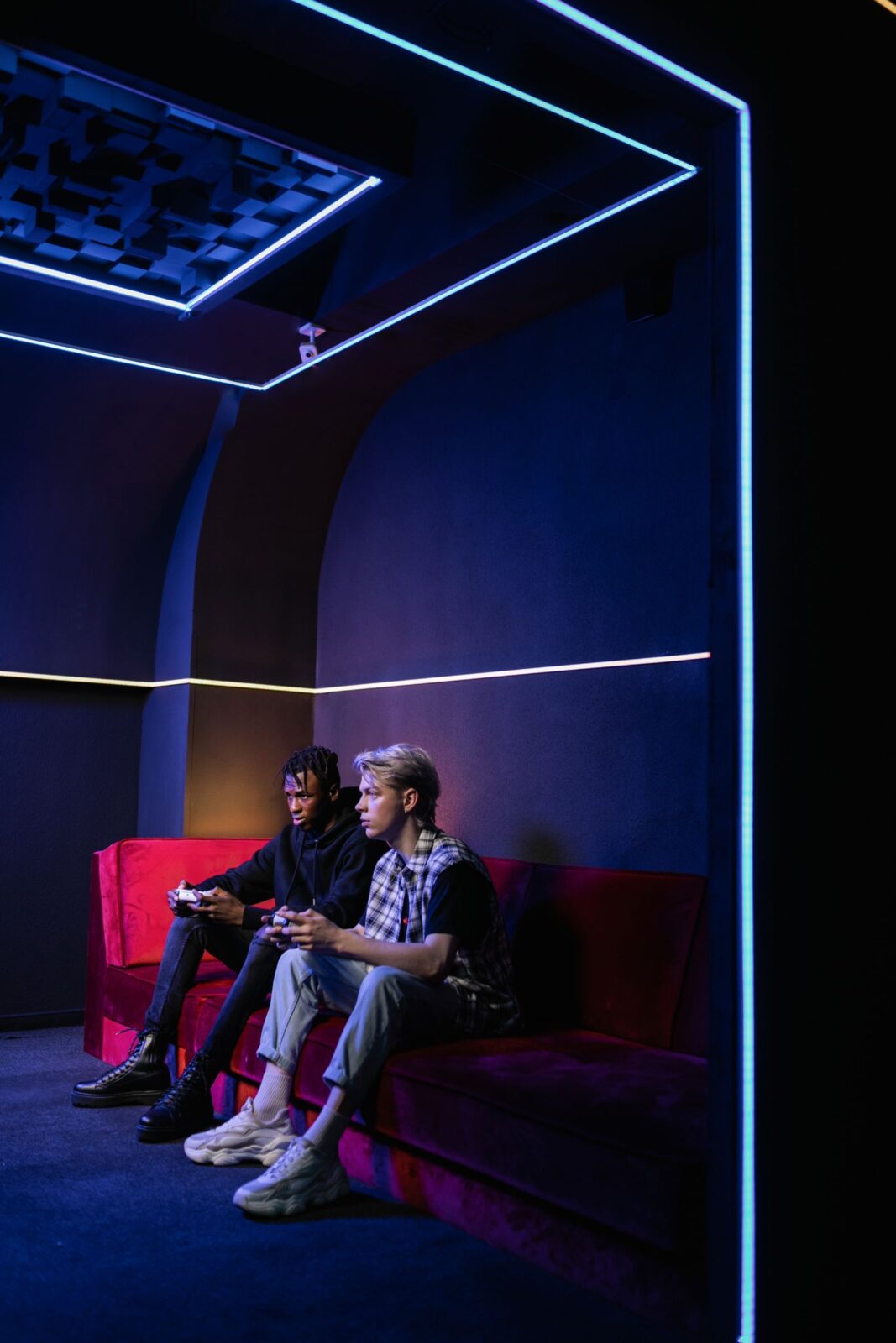 People sitting on a couch playing video games on a TV with controllers