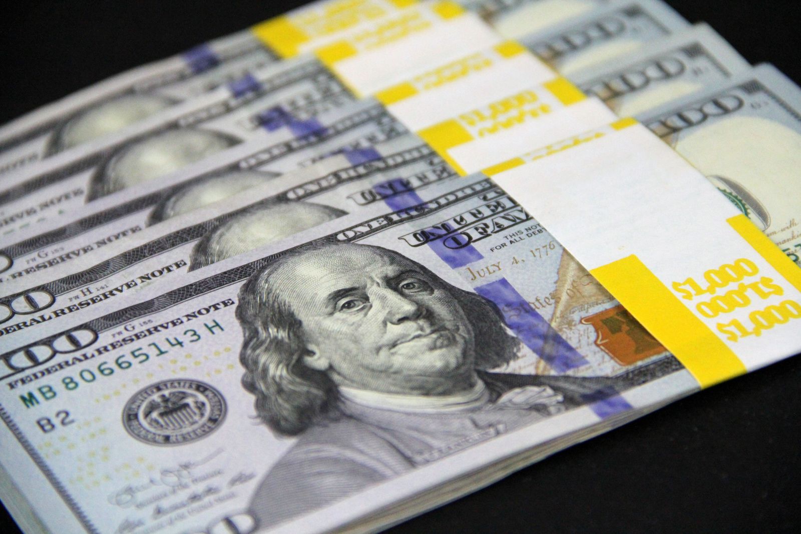 Bundles of hundred dollar bills representing high brand-name medication costs