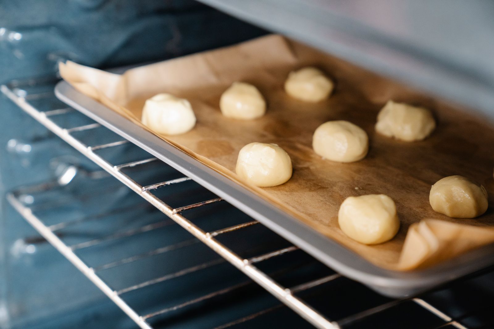 Rounded balls of cookie dough on a baking tray ready for the oven