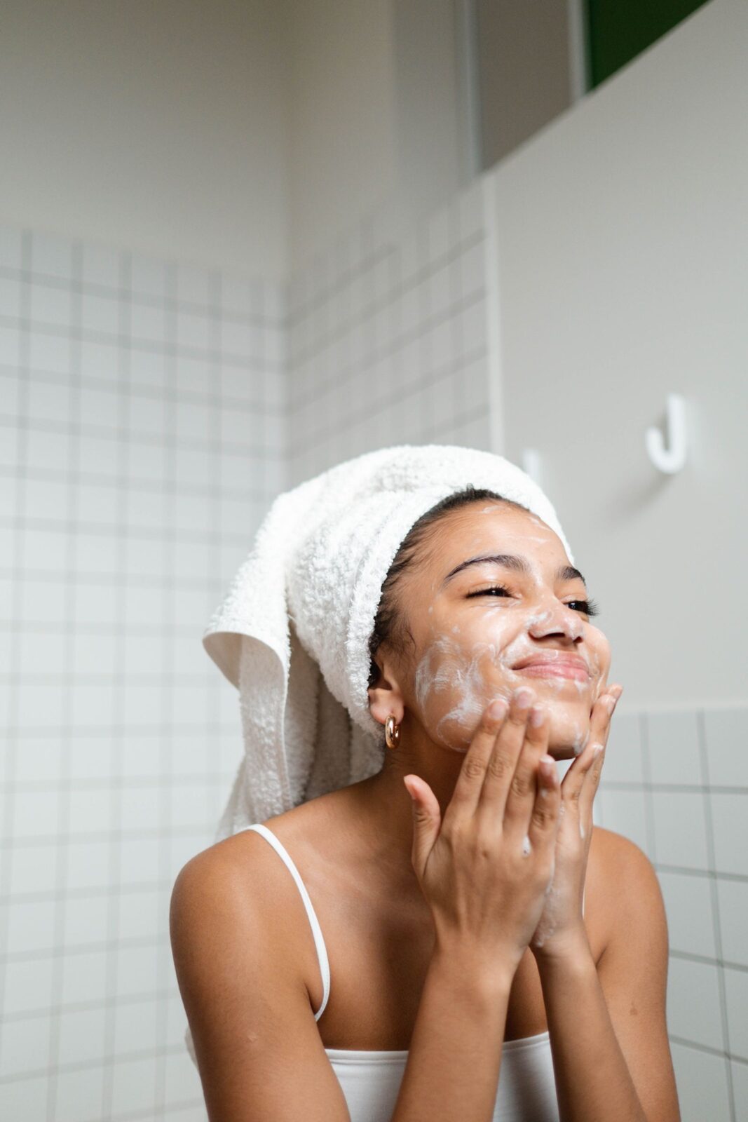 A woman cleansing and washing her face