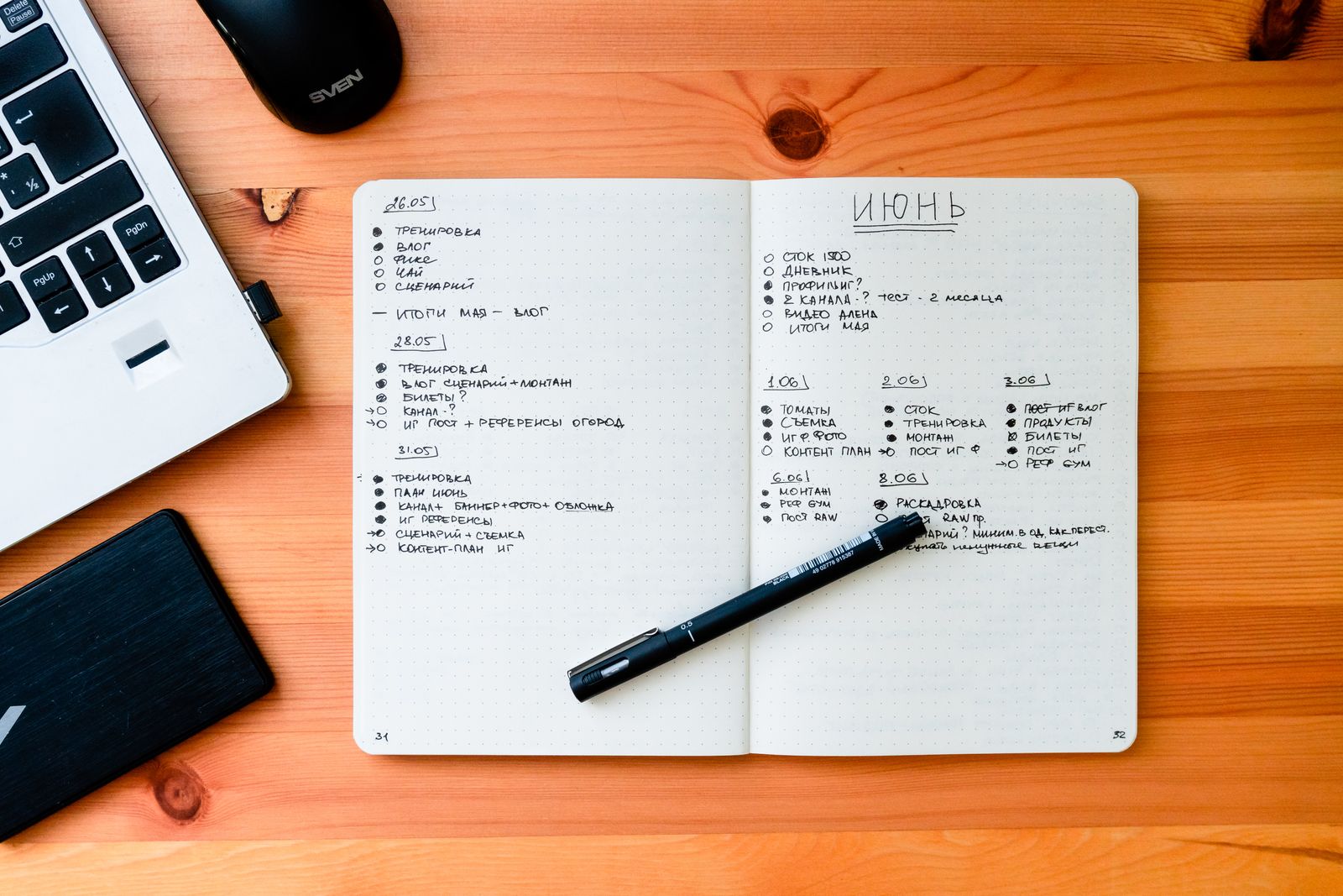 A notebook and pen on a work desk