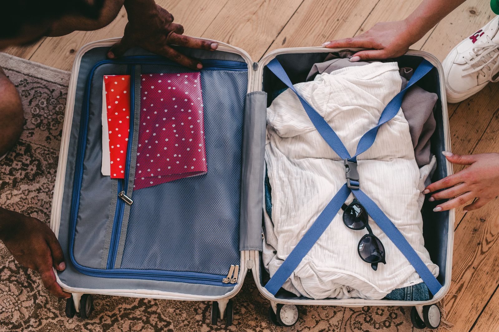 Clothes and accessories neatly organized in an open suitcase