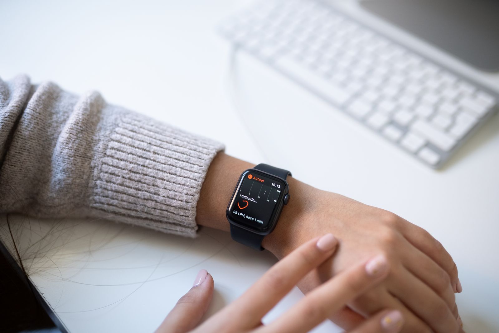A person checking a sports watch on their wrist