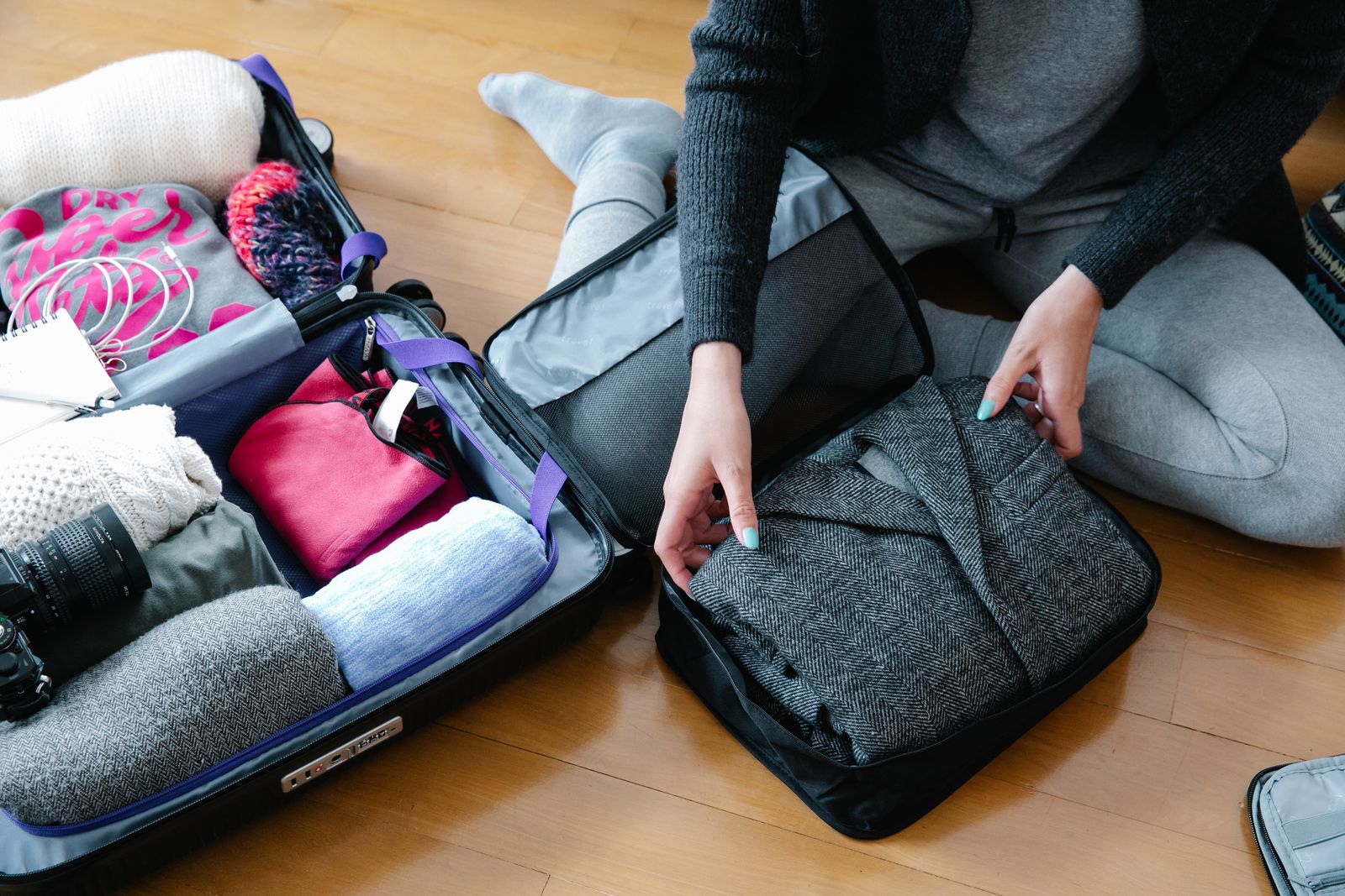 Clear plastic under-bed storage box filled with neatly folded clothes