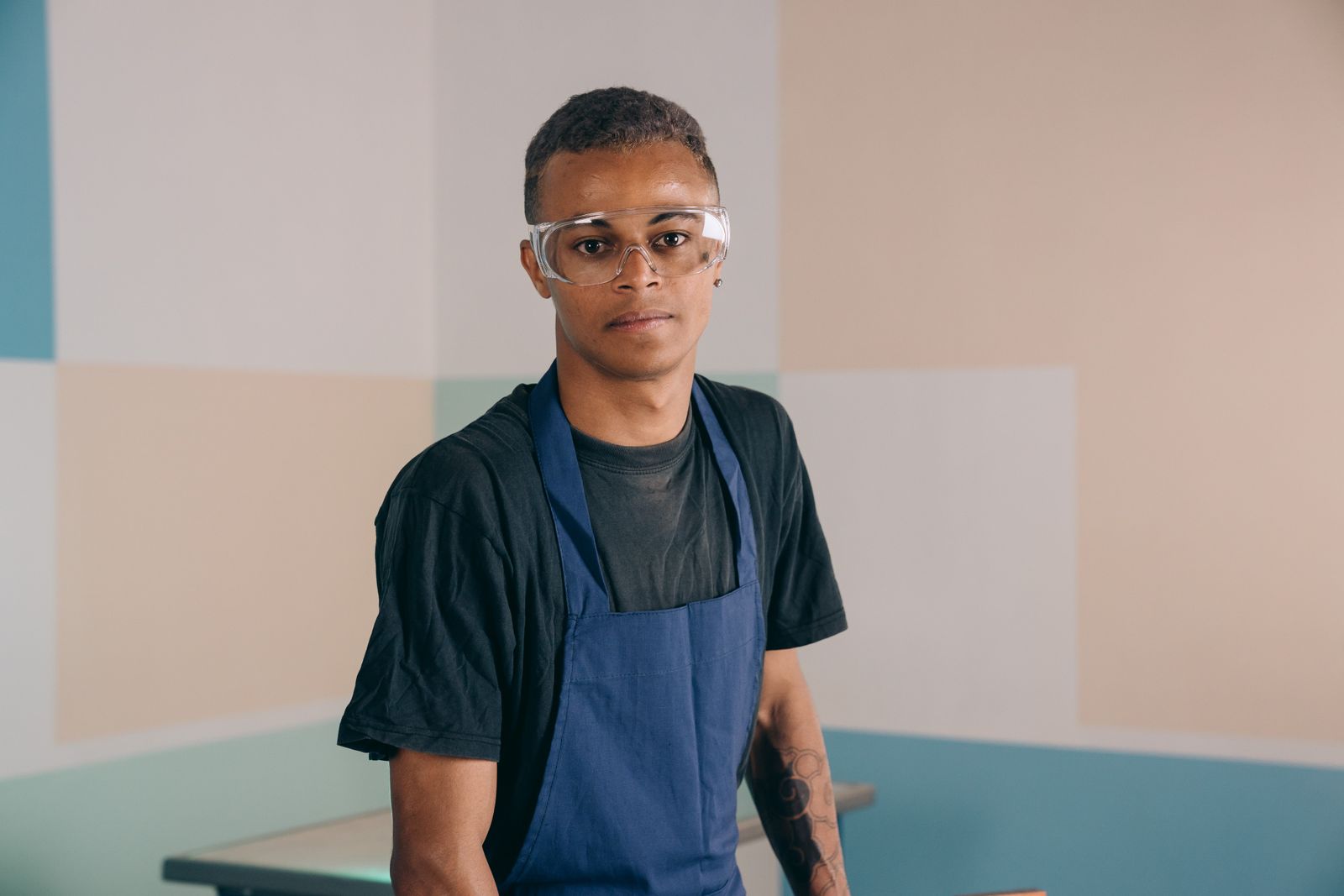 A man wearing protective safety glasses in a workshop