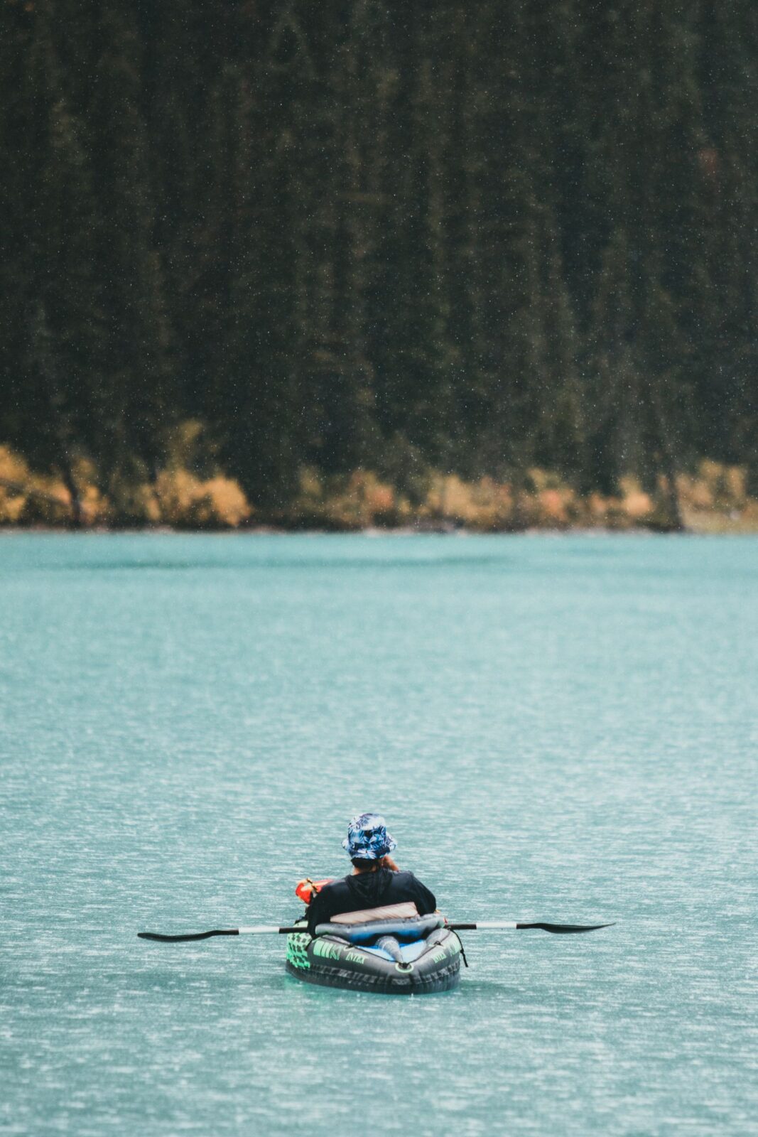 A person kayaking on a calm lake