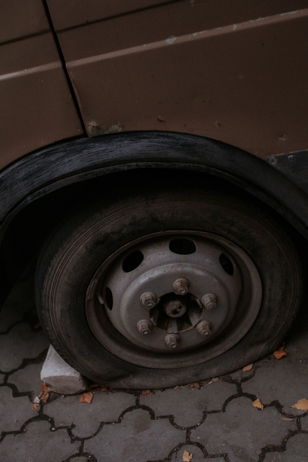 Close-up of a flat car tire on the road