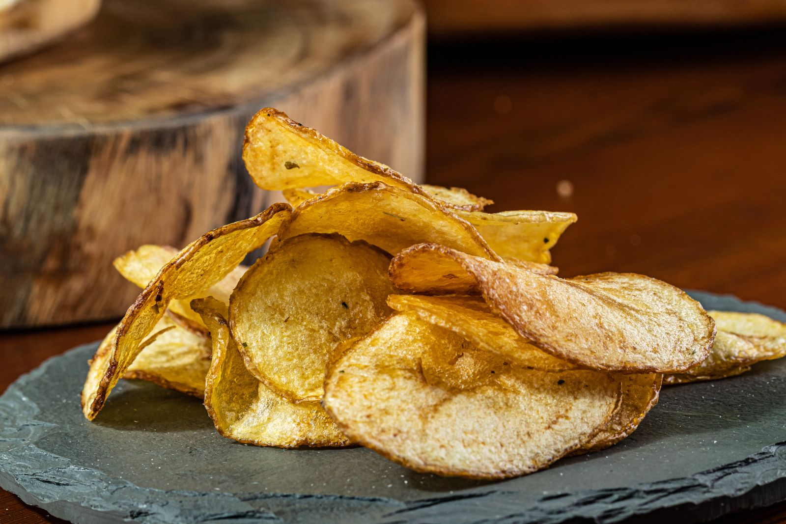 A bowl of thin, evenly cut crunchy potato chips